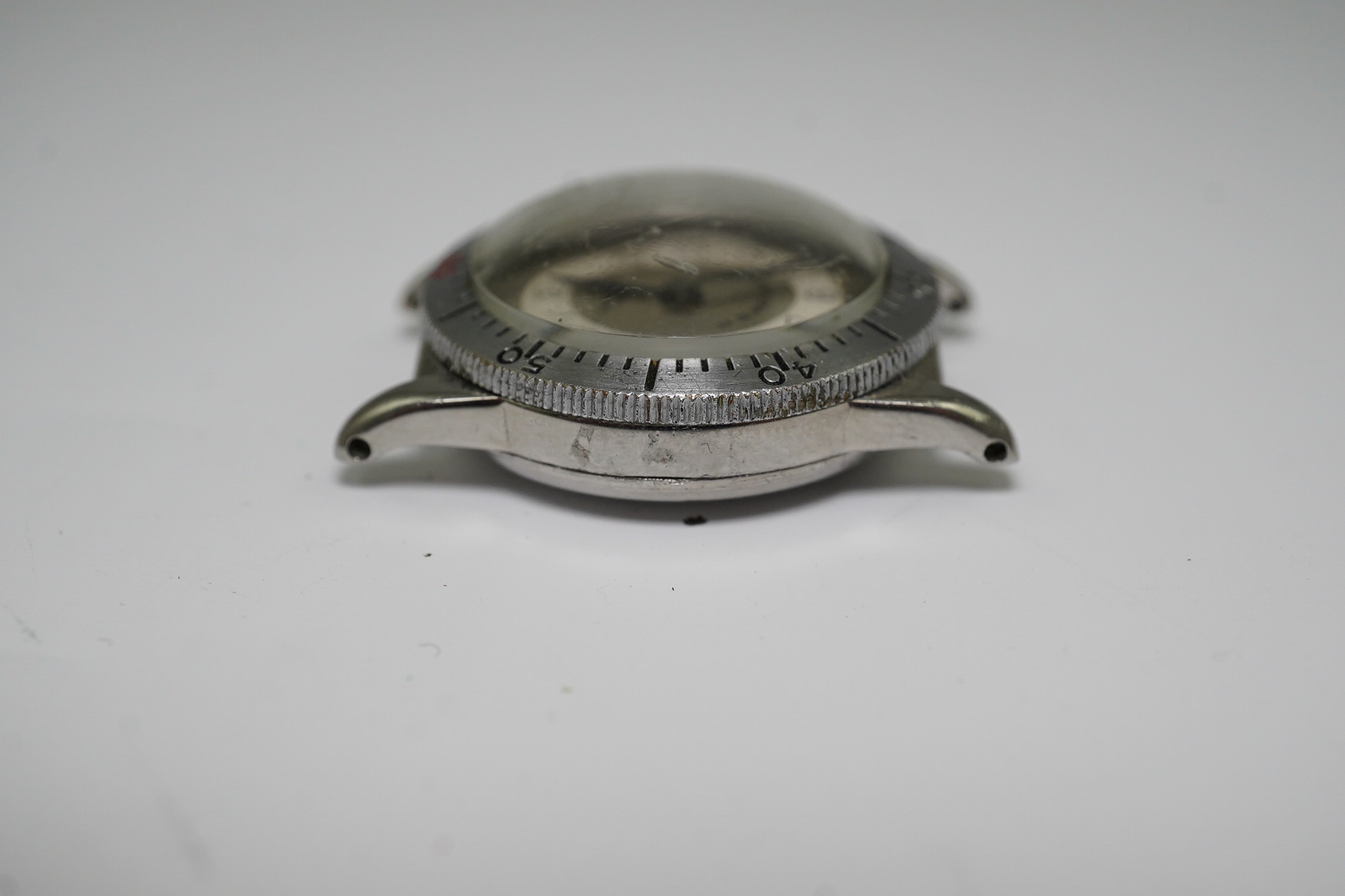 A gentleman's late 1930's steel Longines Weems U.S Patent military pilot's manual wind wrist watch, with Arabic dial, movement c.10L, case diameter 28mm, lacking one crown, no strap. Condition - poor